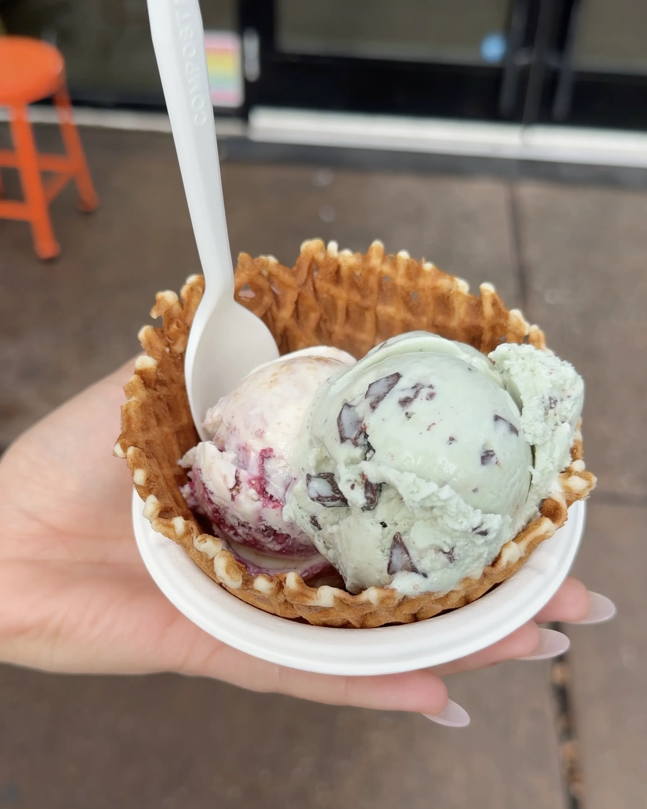 Two scoops of ice cream in a waffle bowl