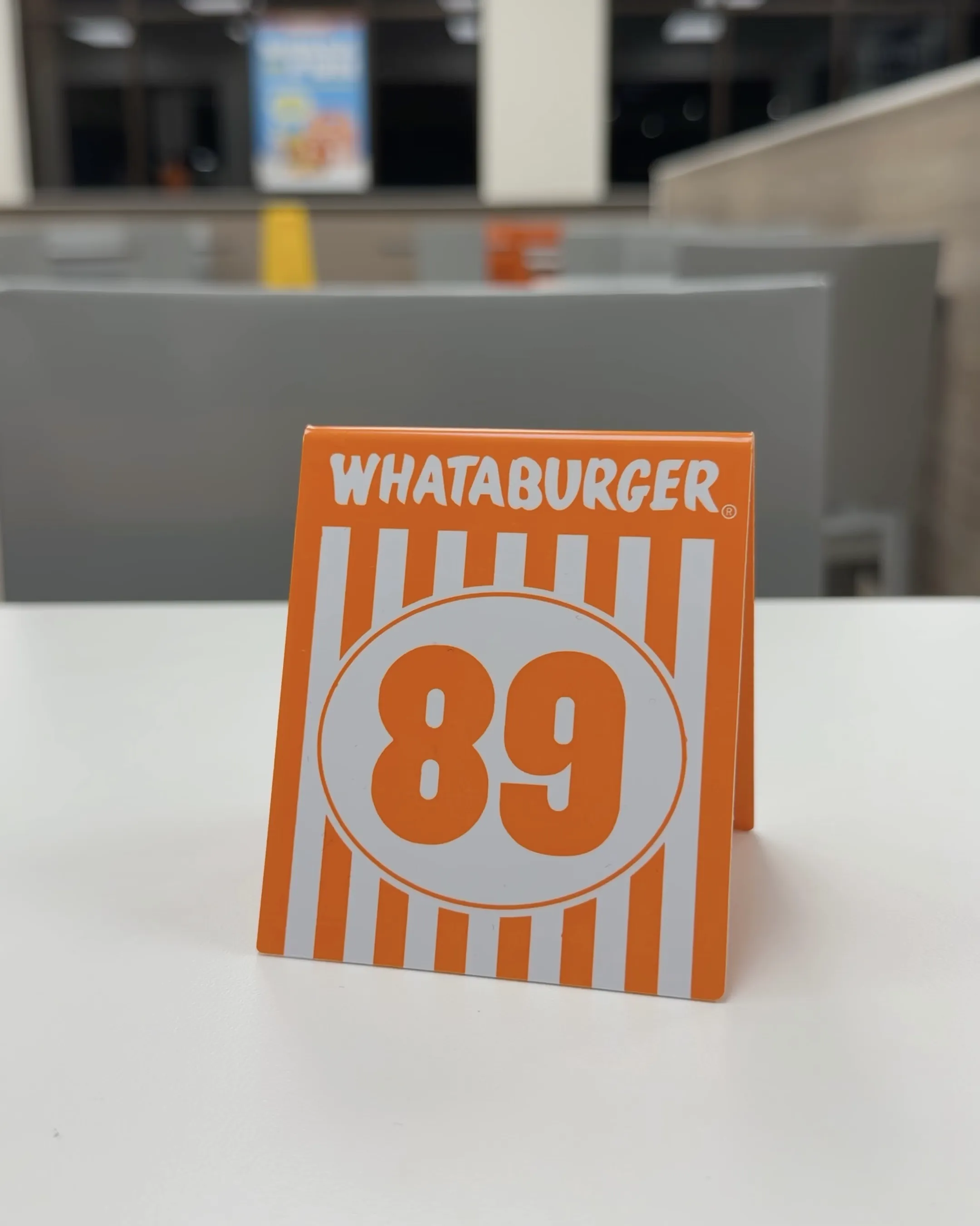The orange and white Whataburger table number tent