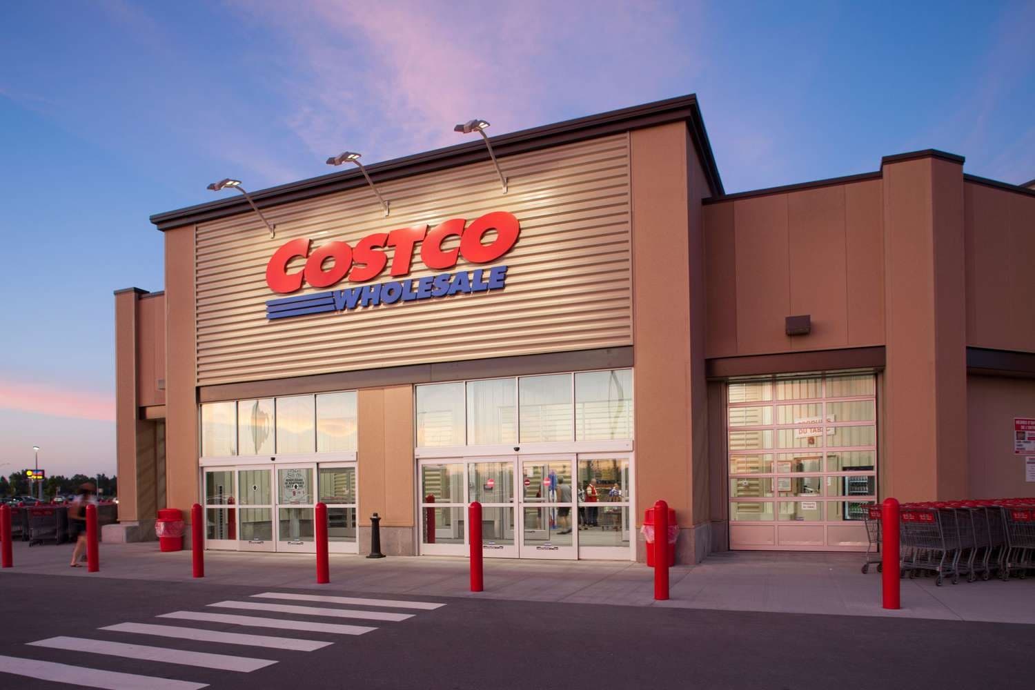 A Costco Wholesale warehouse entrance at dusk