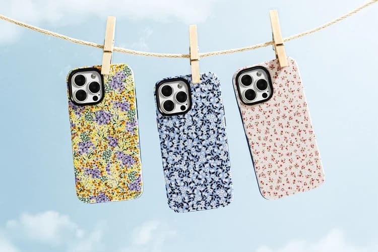Three Casely floral cases hanging from a clothesline: yellow, blue and pink ditsy prints