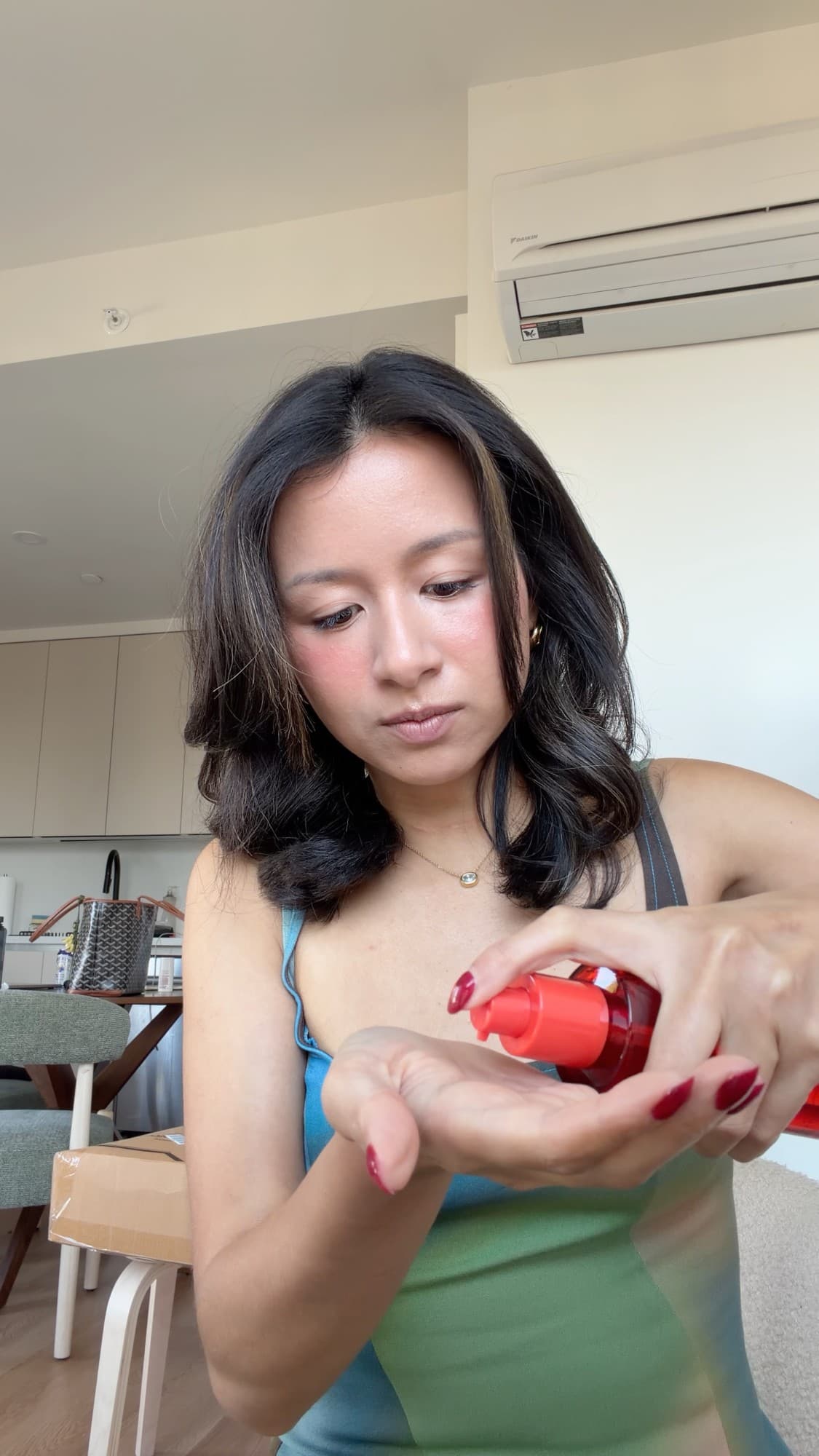 Eileen dispensing the Cyklar body oil into her palm