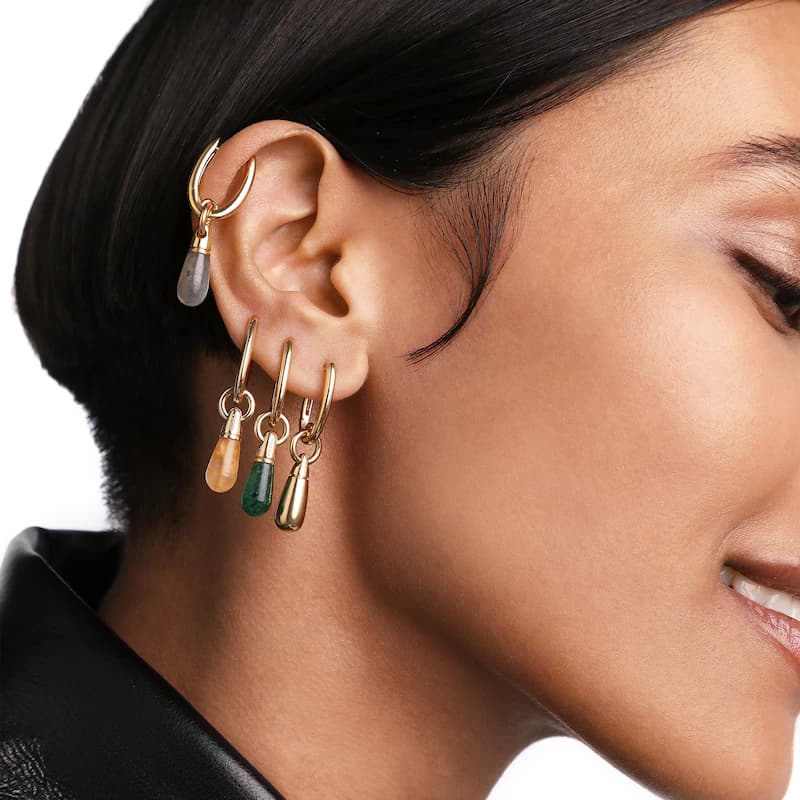 PDPAOLA gold drop earrings worn on the ear