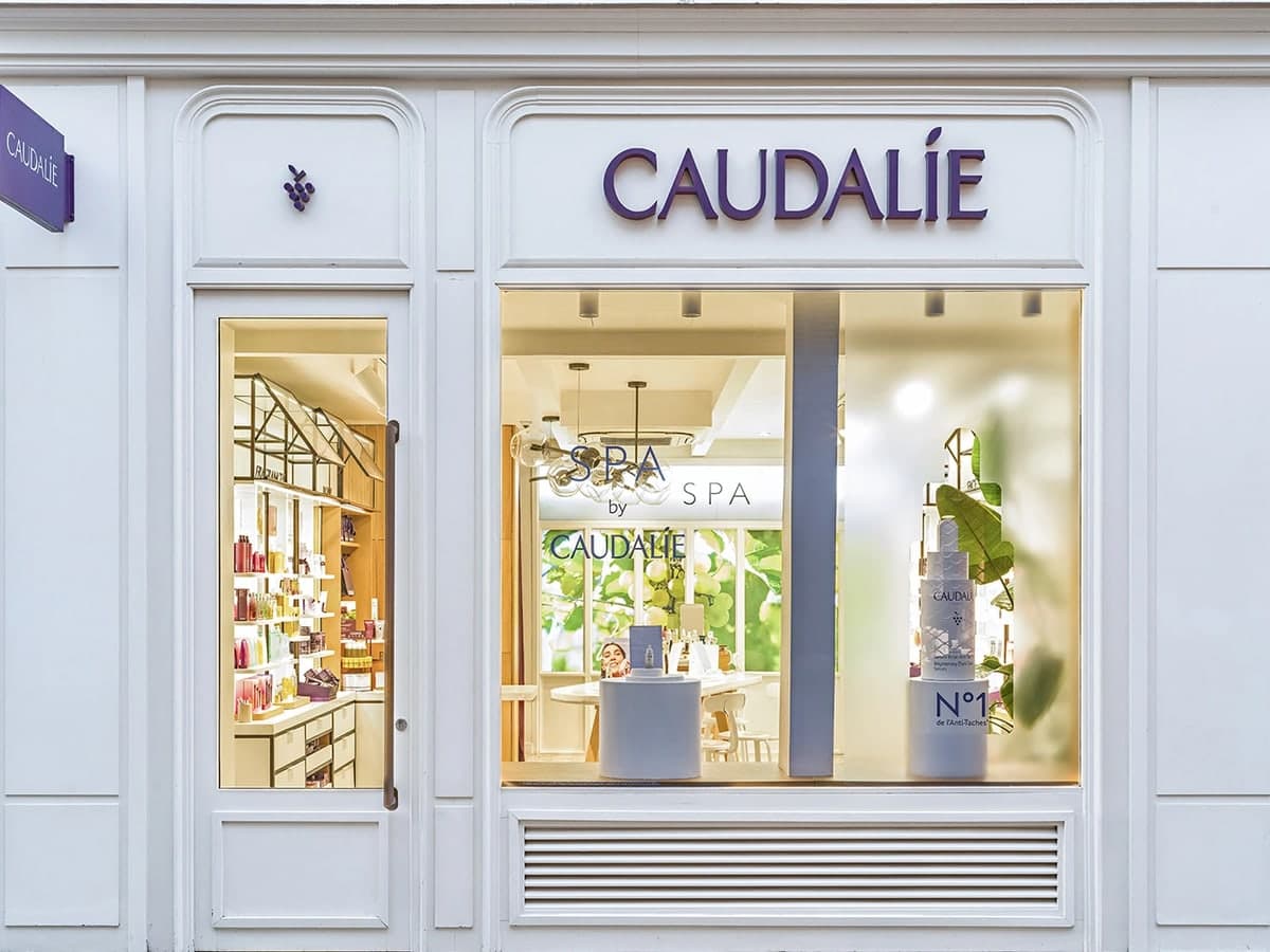 The white Caudalie boutique with its purple sign and spa visible through the window